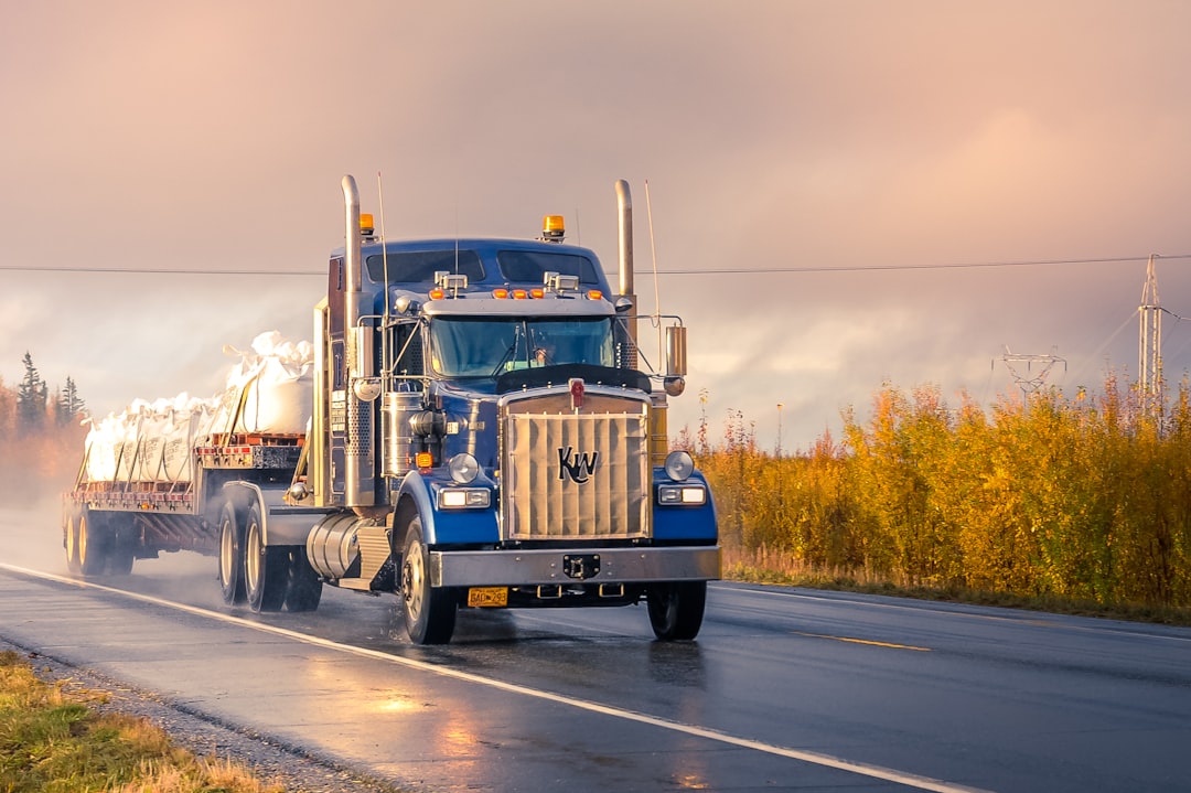 Flatbed truck hauling wrapped cargo