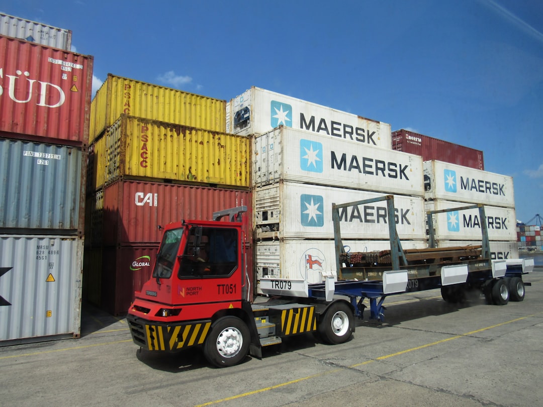 Terminal tractor moving shipping containers at a port